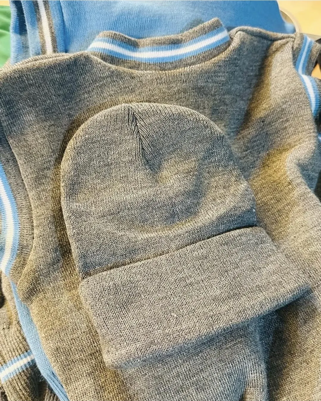 Grey knitted jersey and beanie close-up