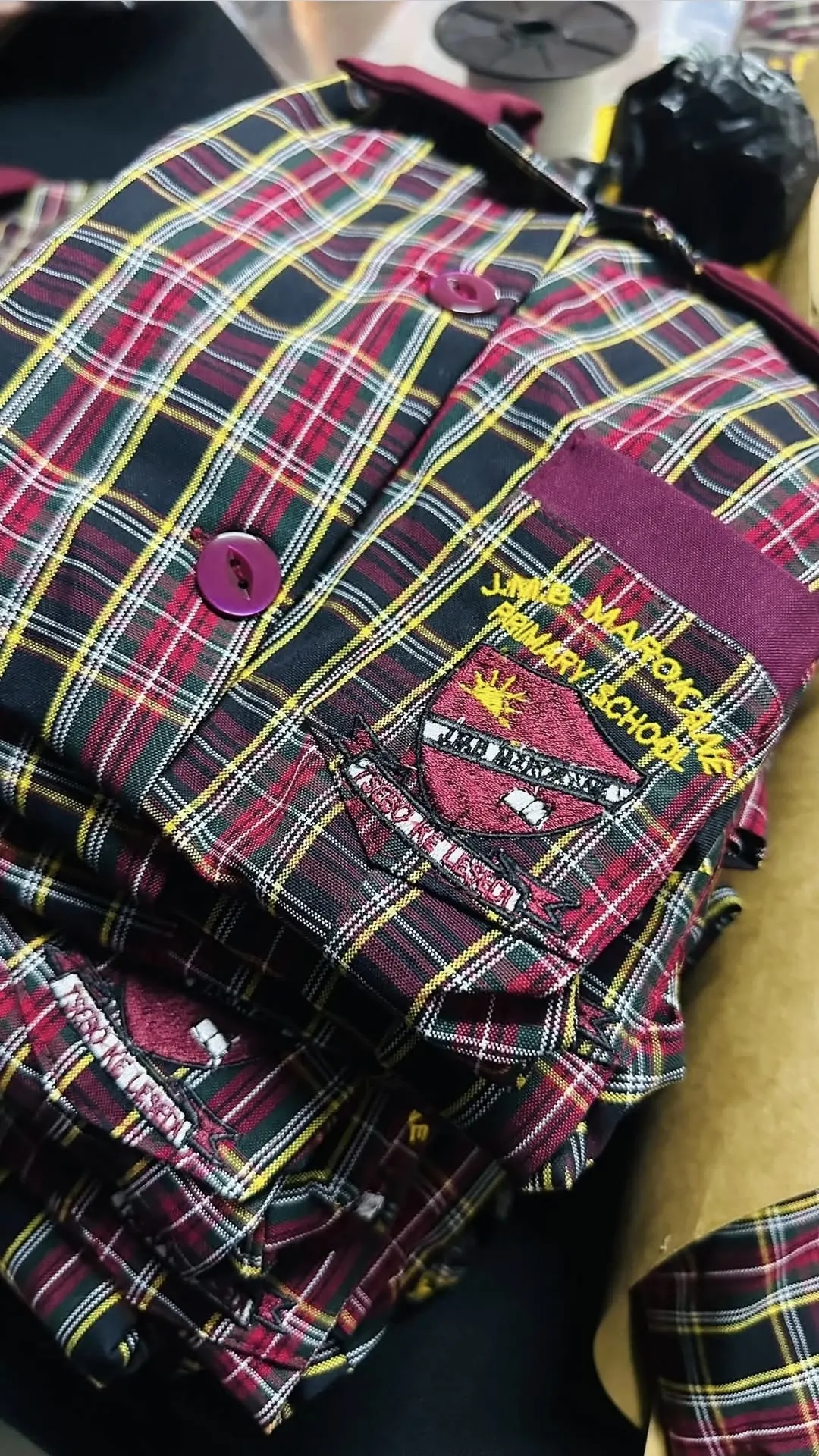 JMB Marokane Primary School tartan shirts with embroidered crest, folded and finished