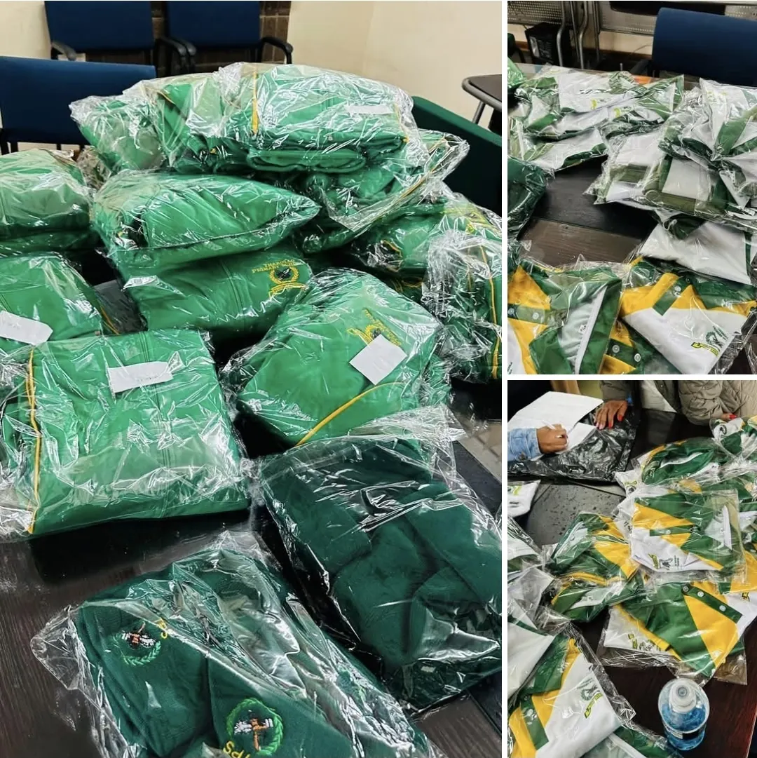 Green and gold school tracksuits packed and sorted for delivery