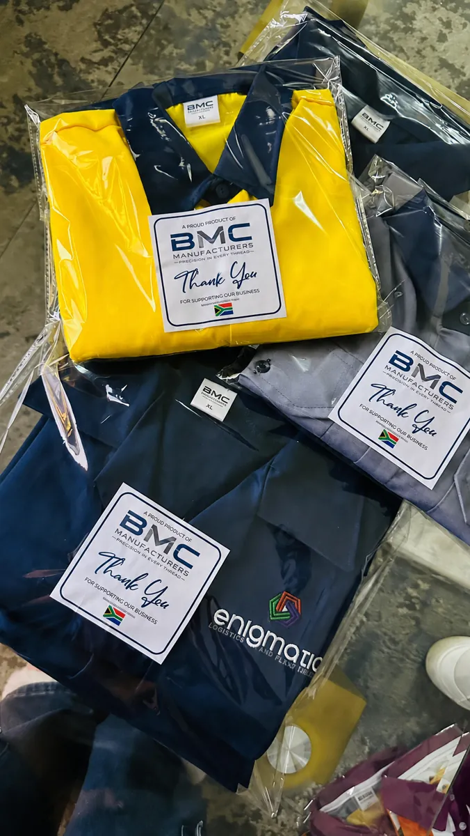 Yellow, grey and navy work shirts individually bagged with BMC labels, ready for delivery to Enigmatic Logistics and Plant Hire